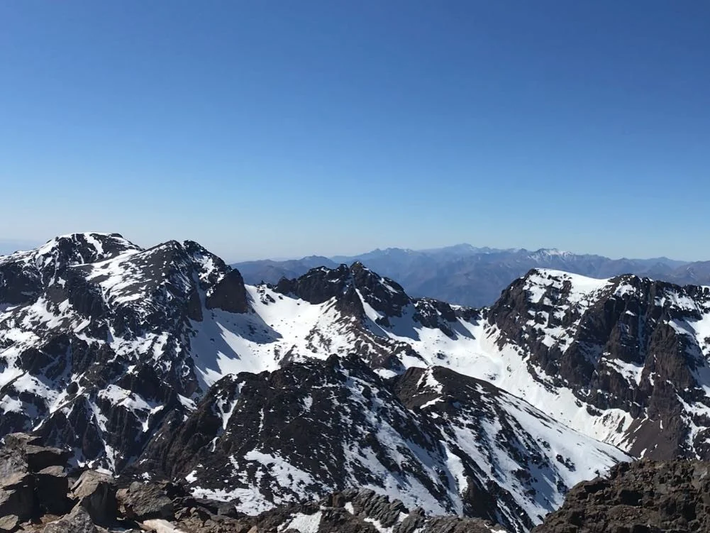Snow-covered peaks of the High Atlas under a blue sky